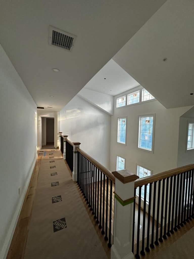 Hallway railing with black iron balusters