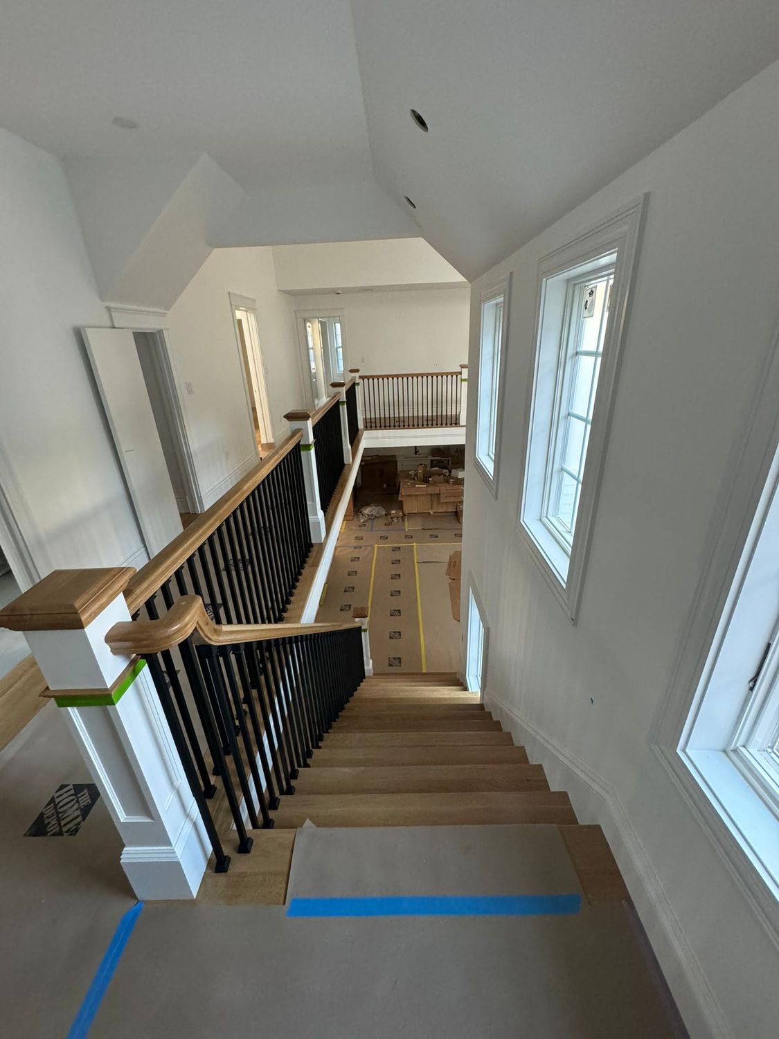 Staircase with oak treads, white risers and black iron balusters