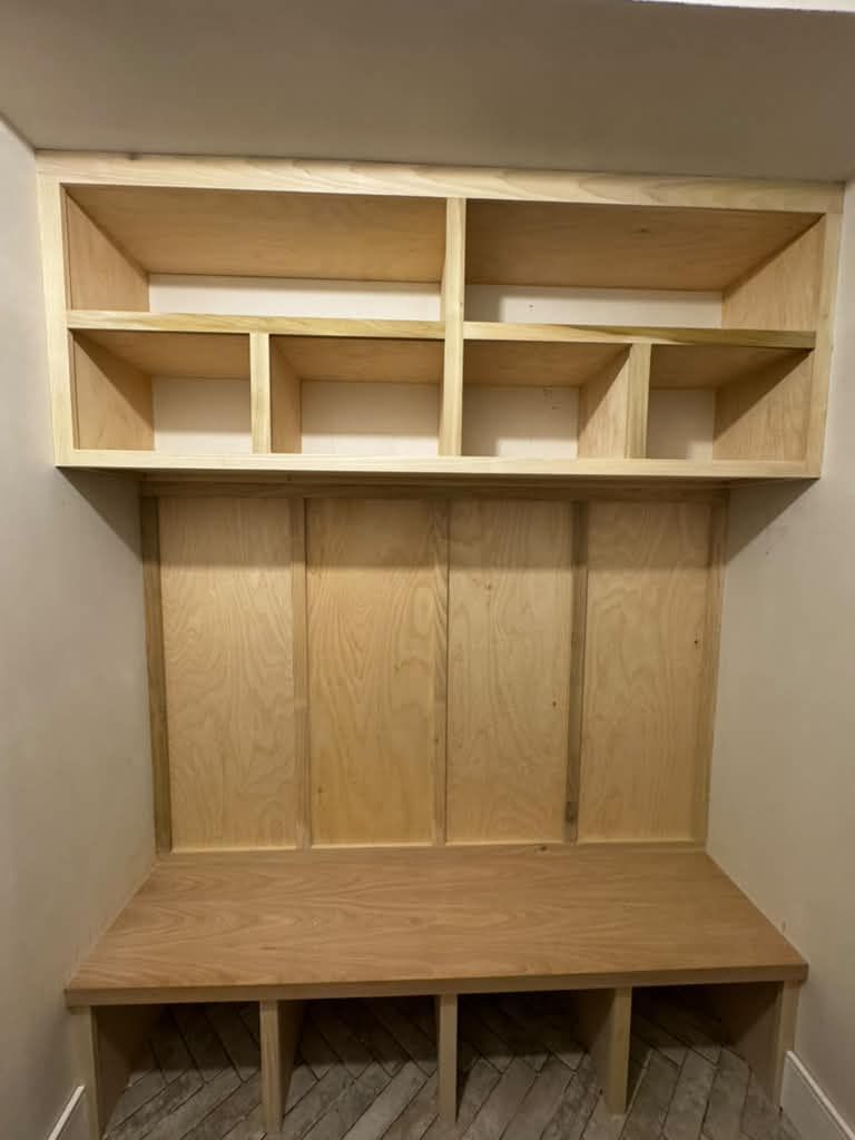 Mudroom built-in with cubbies and bench, before paint