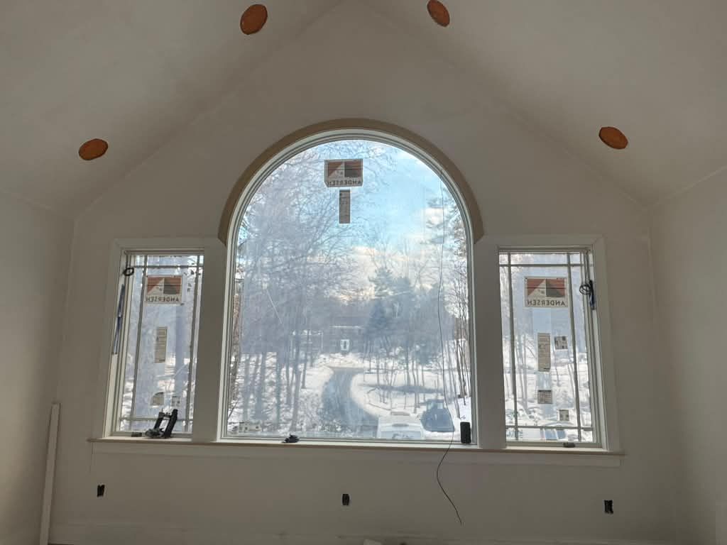 Arched window with side lights and casing