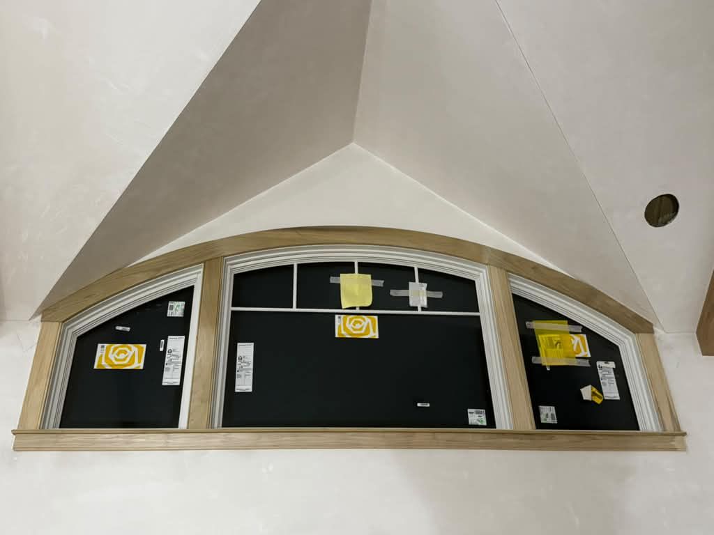 Arched window wrapped in wood casing